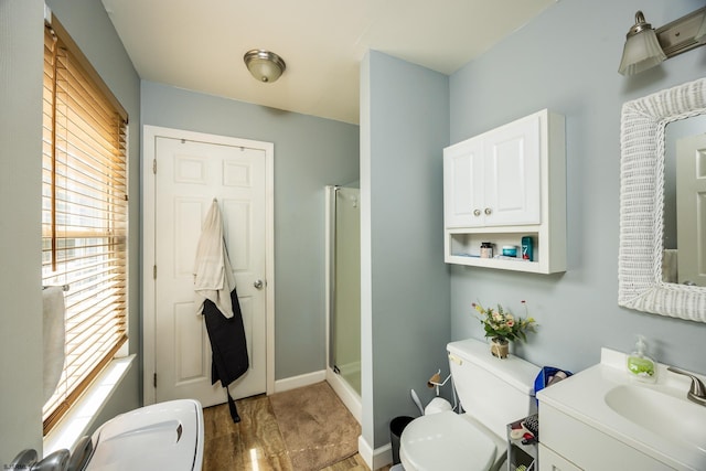 bathroom with toilet, an enclosed shower, and vanity