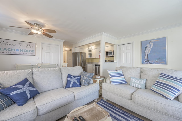 living room with ceiling fan and crown molding