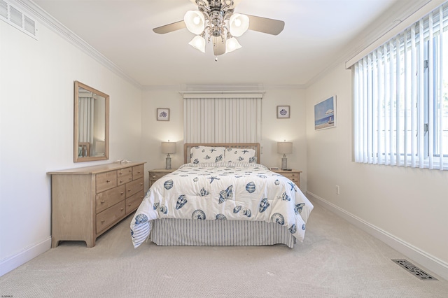 carpeted bedroom featuring ceiling fan and crown molding