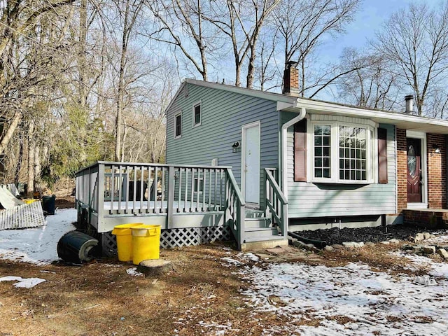 snow covered property with a deck