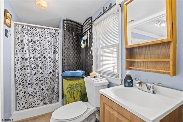 bathroom featuring walk in shower, hardwood / wood-style flooring, vanity, and toilet