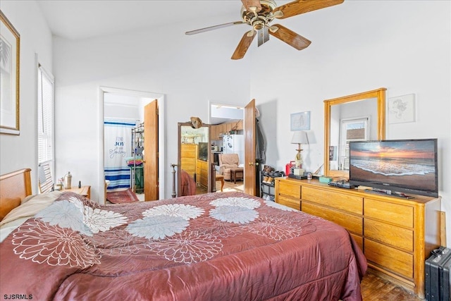 bedroom with connected bathroom, hardwood / wood-style floors, and ceiling fan