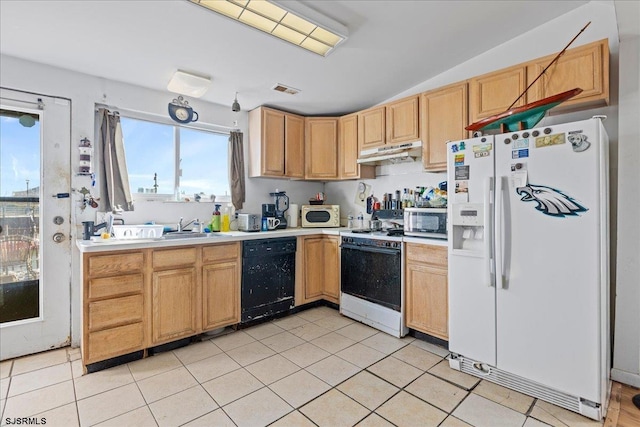 kitchen with white appliances, vaulted ceiling, light tile patterned floors, and sink