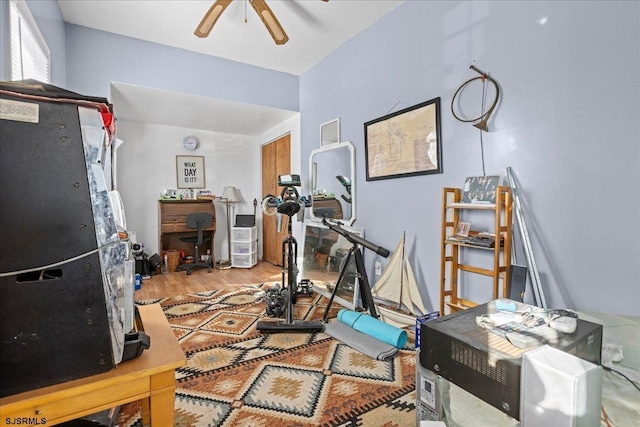 workout area featuring ceiling fan and hardwood / wood-style floors