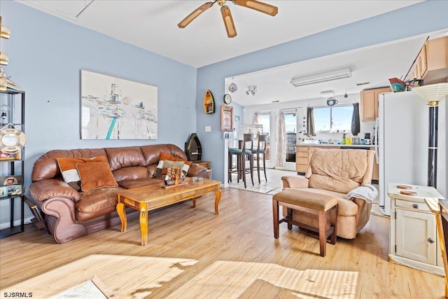 living room featuring light wood-type flooring and ceiling fan