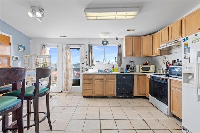 kitchen featuring white appliances and light tile patterned floors