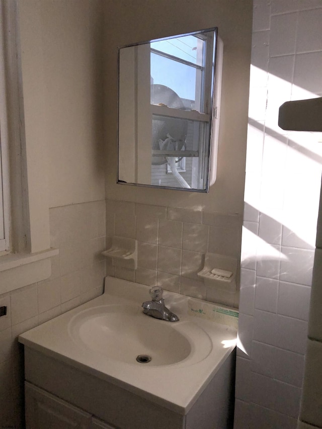 bathroom with tile walls, backsplash, and vanity