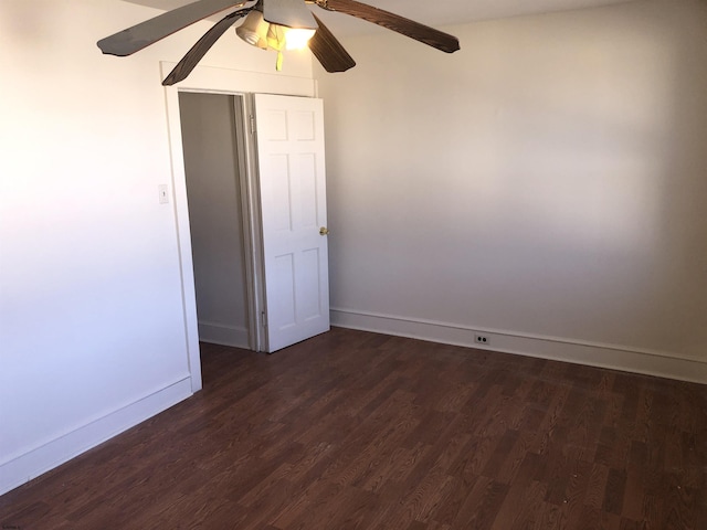 unfurnished room featuring ceiling fan and dark hardwood / wood-style floors