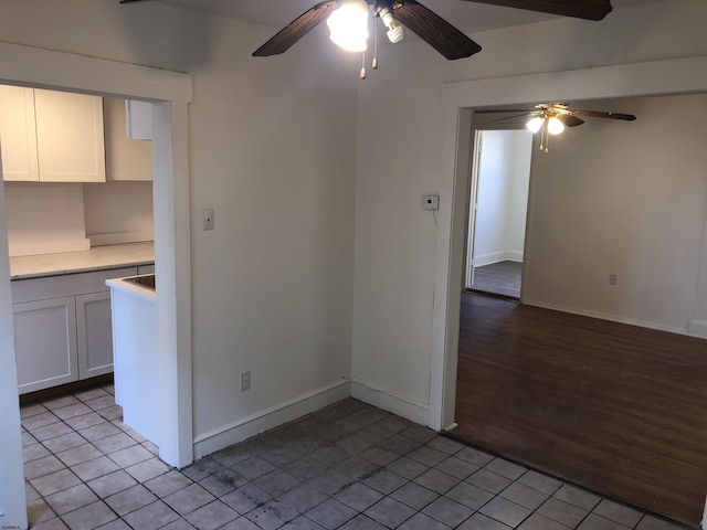 interior space featuring light tile patterned flooring and ceiling fan