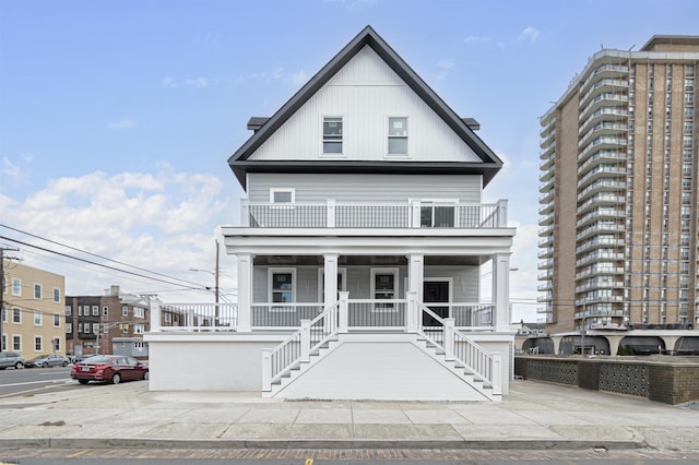 view of front of property featuring a balcony and covered porch