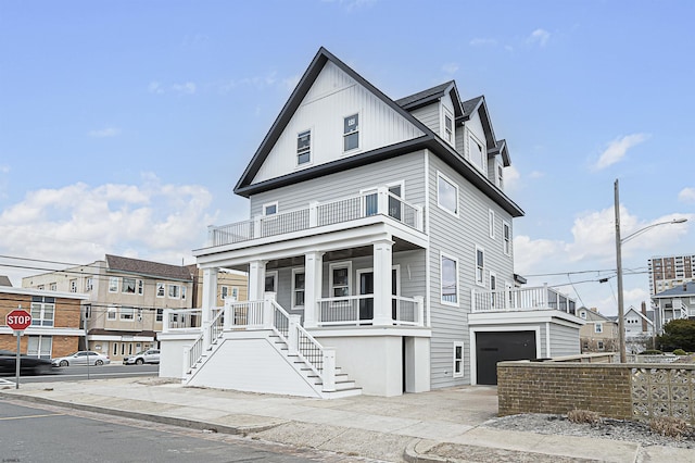 view of front of property with a balcony, a garage, and a porch