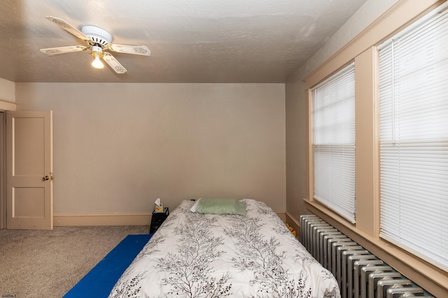 bedroom with radiator, ceiling fan, and carpet flooring