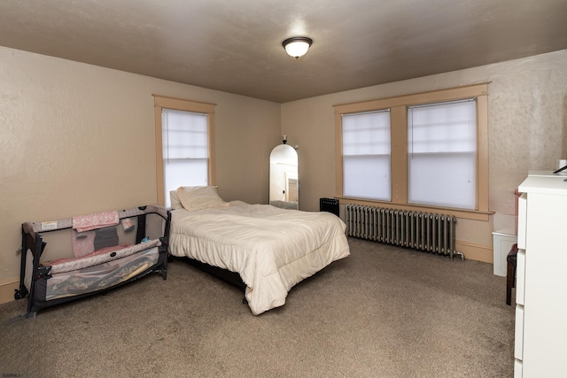 bedroom with carpet flooring and radiator heating unit