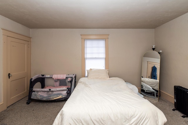 carpeted bedroom featuring radiator