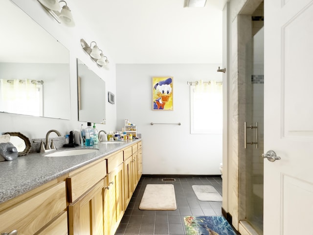 bathroom with toilet, walk in shower, vanity, and tile patterned flooring