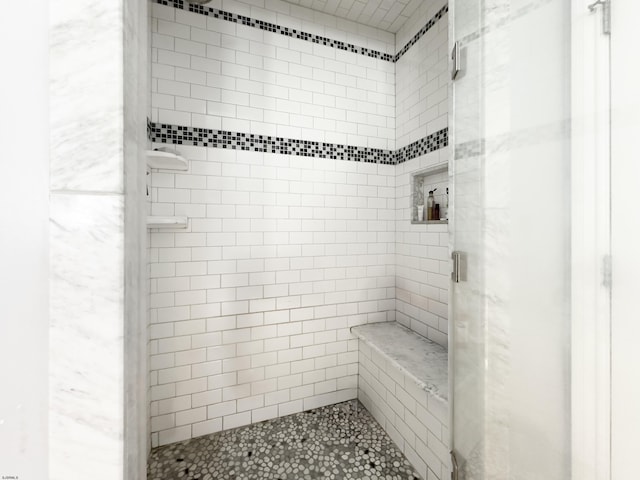 bathroom with a tile shower