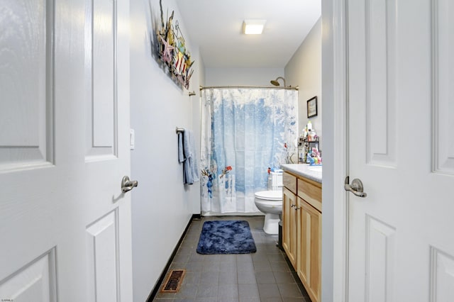 bathroom with toilet, tile patterned flooring, vanity, and curtained shower