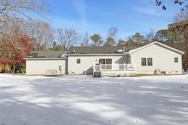 snow covered rear of property featuring a wooden deck and cooling unit