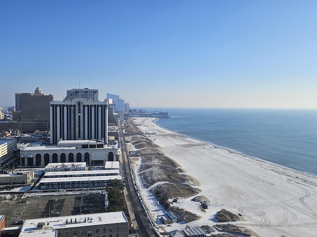 birds eye view of property with a water view and a beach view