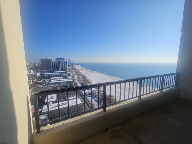 balcony featuring a water view and a view of the beach