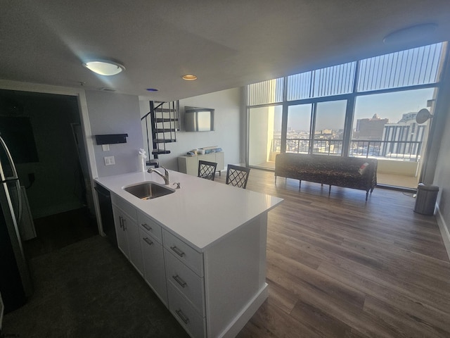 kitchen featuring dishwasher, white cabinetry, sink, dark hardwood / wood-style floors, and stainless steel refrigerator