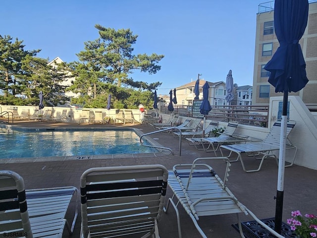 view of swimming pool featuring a patio area