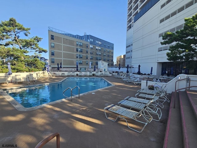 view of swimming pool with a patio