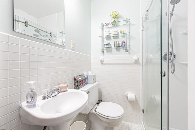 bathroom featuring sink, tile walls, toilet, and an enclosed shower