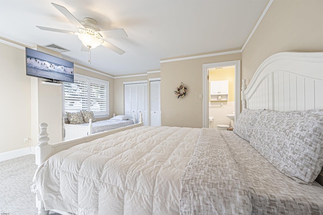 bedroom featuring ceiling fan, ensuite bath, carpet, and crown molding