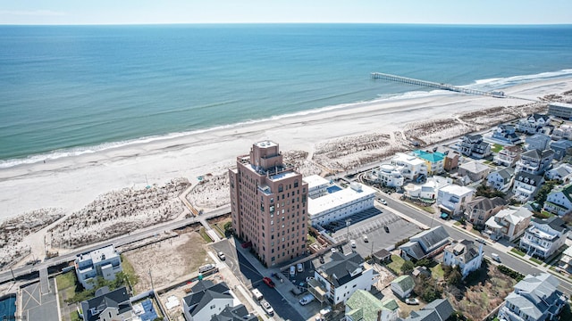 bird's eye view with a water view and a beach view