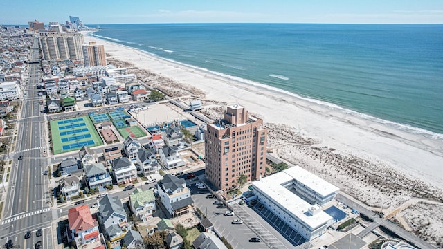 drone / aerial view with a water view and a view of the beach