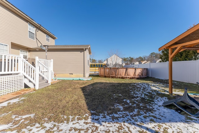 snowy yard featuring a swimming pool side deck