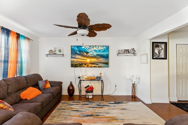 living room with dark wood-type flooring and ceiling fan