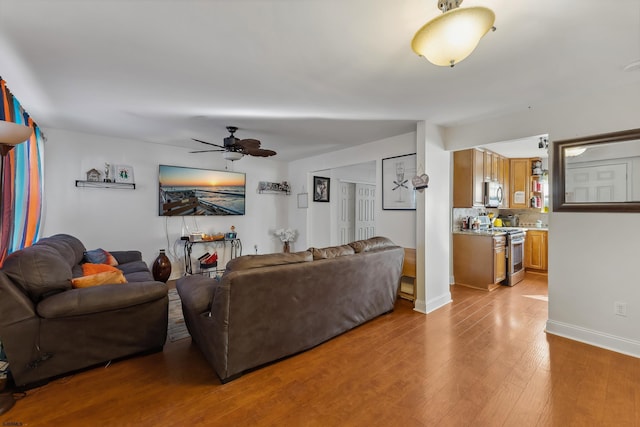 living room featuring ceiling fan and light wood-type flooring