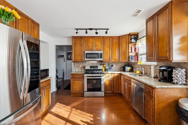 kitchen with stainless steel appliances, decorative backsplash, dark hardwood / wood-style floors, and sink