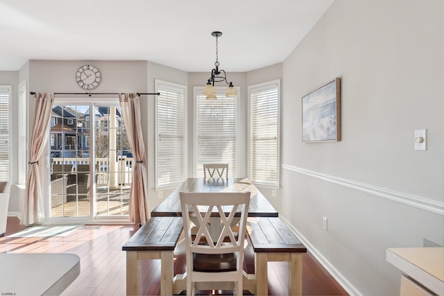 dining space with an inviting chandelier and wood-type flooring