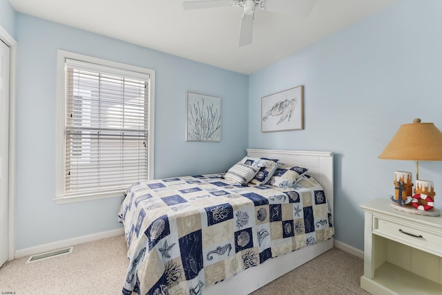 bedroom with ceiling fan and light carpet