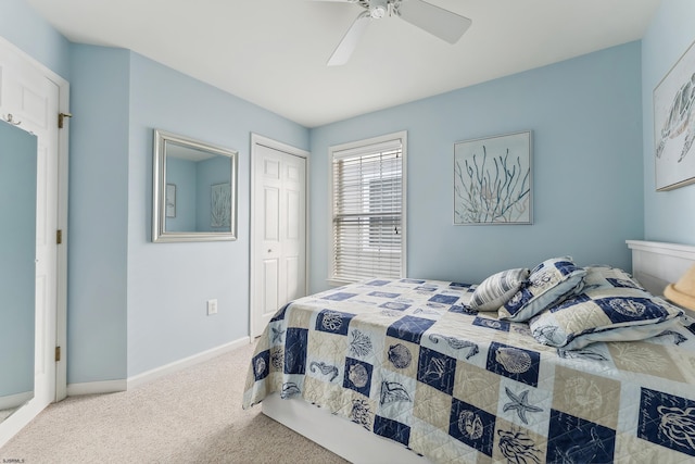 bedroom featuring ceiling fan, light colored carpet, and a closet