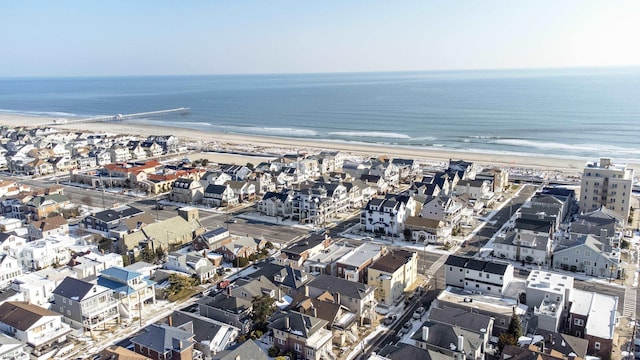 birds eye view of property with a water view and a view of the beach