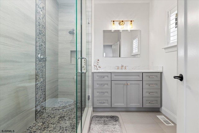 bathroom with vanity, tile patterned flooring, and a shower with door