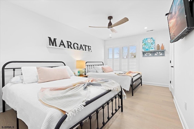 bedroom with ceiling fan and light hardwood / wood-style flooring