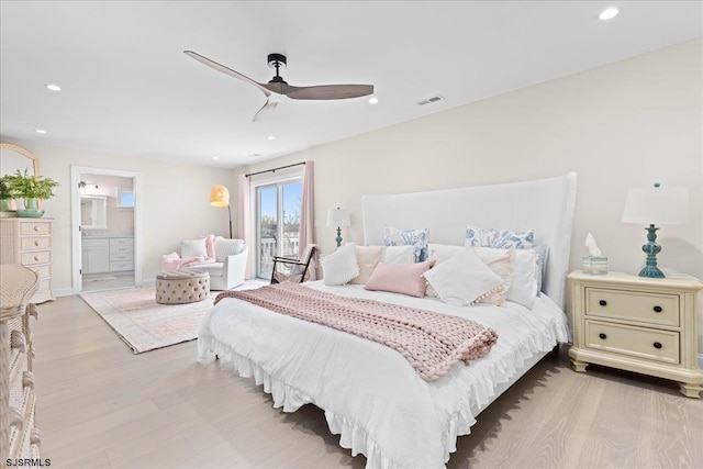 bedroom featuring ceiling fan, ensuite bath, and light hardwood / wood-style flooring