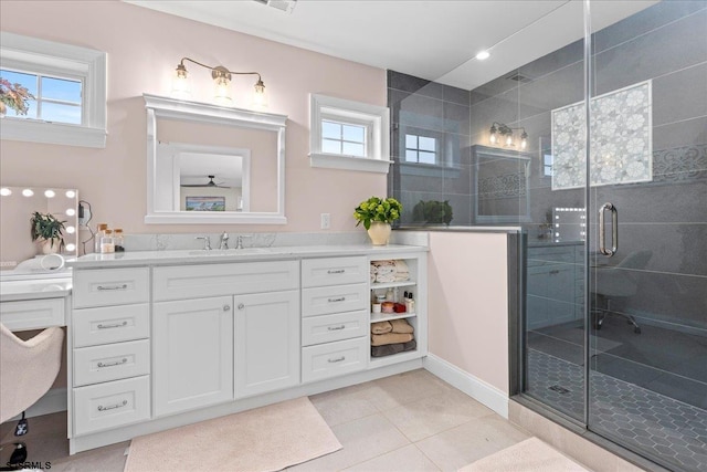 bathroom featuring a healthy amount of sunlight, vanity, a shower with door, and tile patterned floors