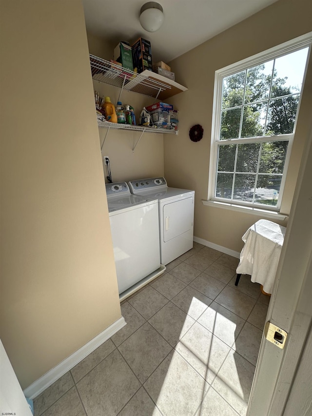 laundry area with light tile patterned floors and washer and dryer