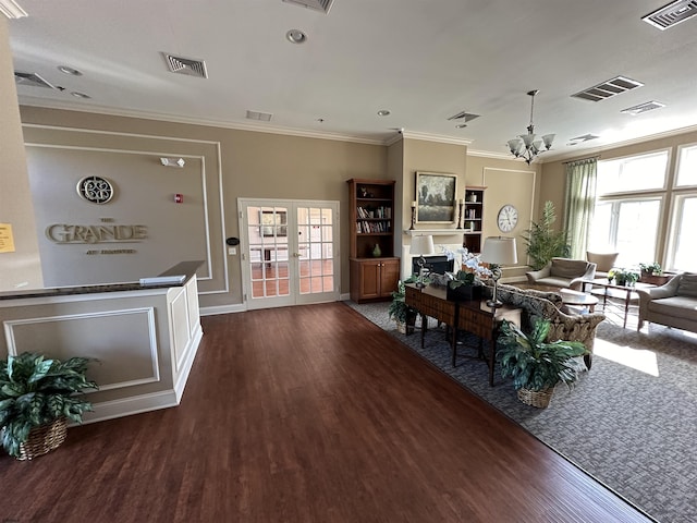 dining area with an inviting chandelier, ornamental molding, and dark hardwood / wood-style floors