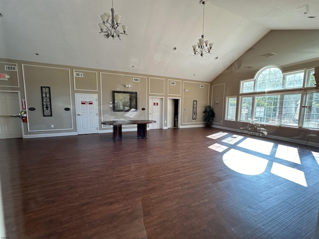 interior space featuring high vaulted ceiling, dark hardwood / wood-style flooring, and a chandelier