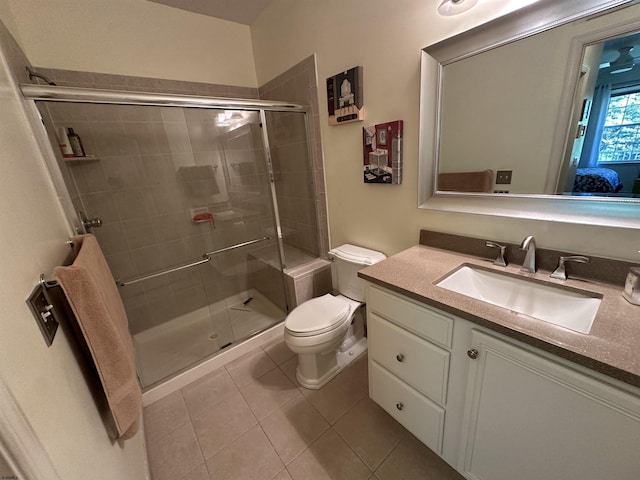 bathroom with toilet, tile patterned flooring, walk in shower, and vanity