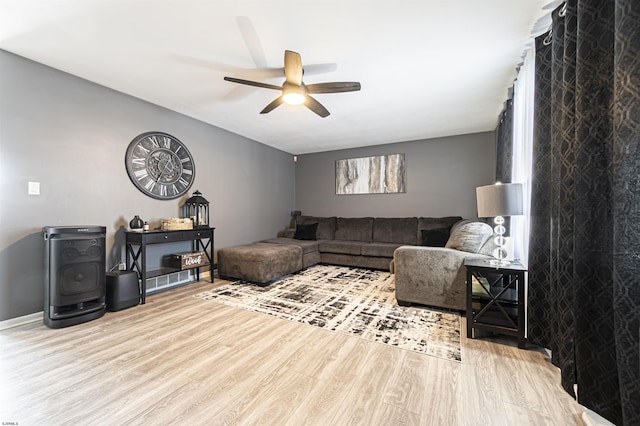 living room featuring ceiling fan and light hardwood / wood-style flooring