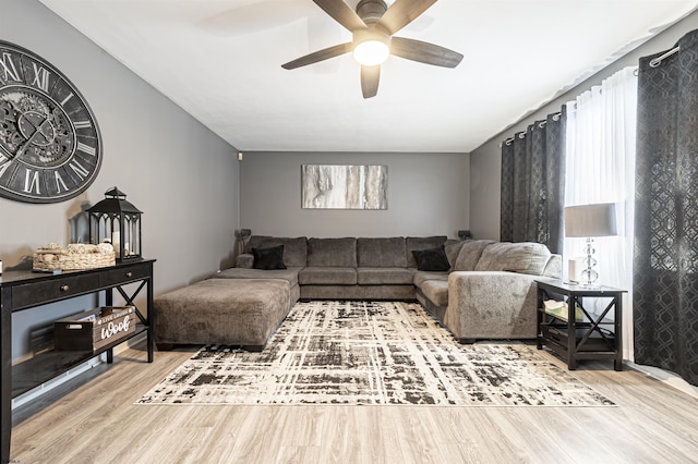 living room featuring ceiling fan and wood-type flooring