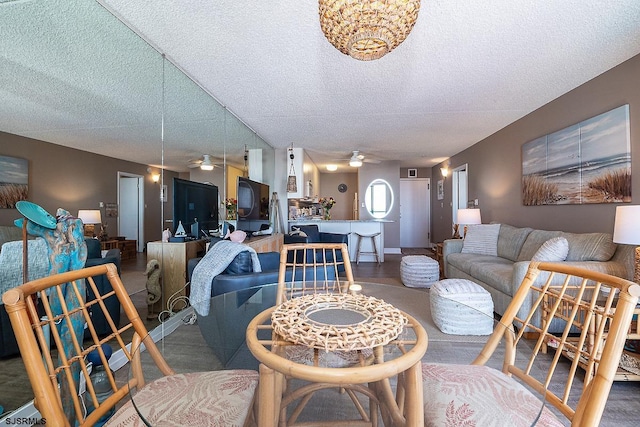 living room featuring a textured ceiling and ceiling fan